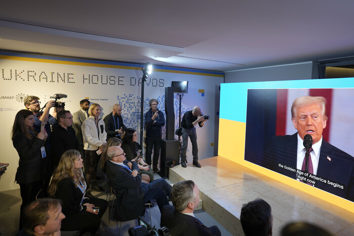 지난 20일(현지 시간) 스위스 다보스에서 세계경제포럼(WEF·다보스포럼)이 열린 가운데 우크라이나 하우스에 모인 사람들이 스크린을 통해 도널드 트럼프 미국 대통령의 취임식을 시청하고 있다. 사진=AP/뉴시스