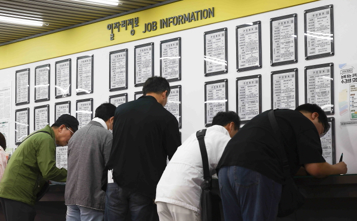 서울 마포구 서부고용복지플러스센터 일자리 정보 게시판에서 구직자들이 이력서를 작성하고 있다. 사진=뉴시스